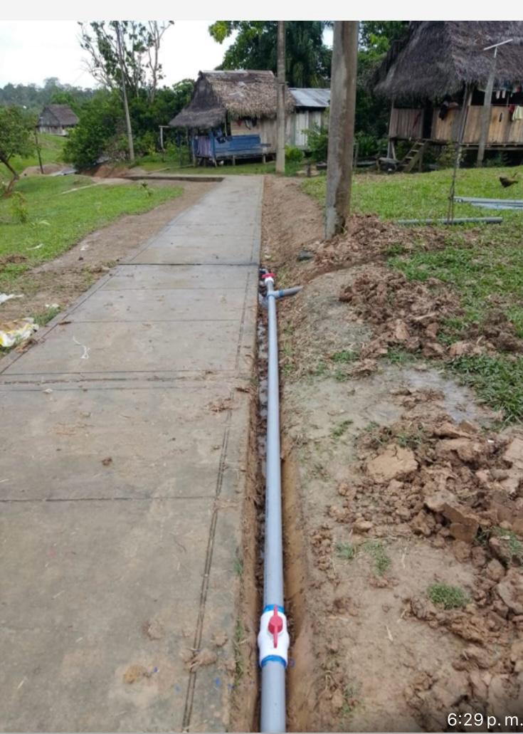 New water distribution lines beside a village path